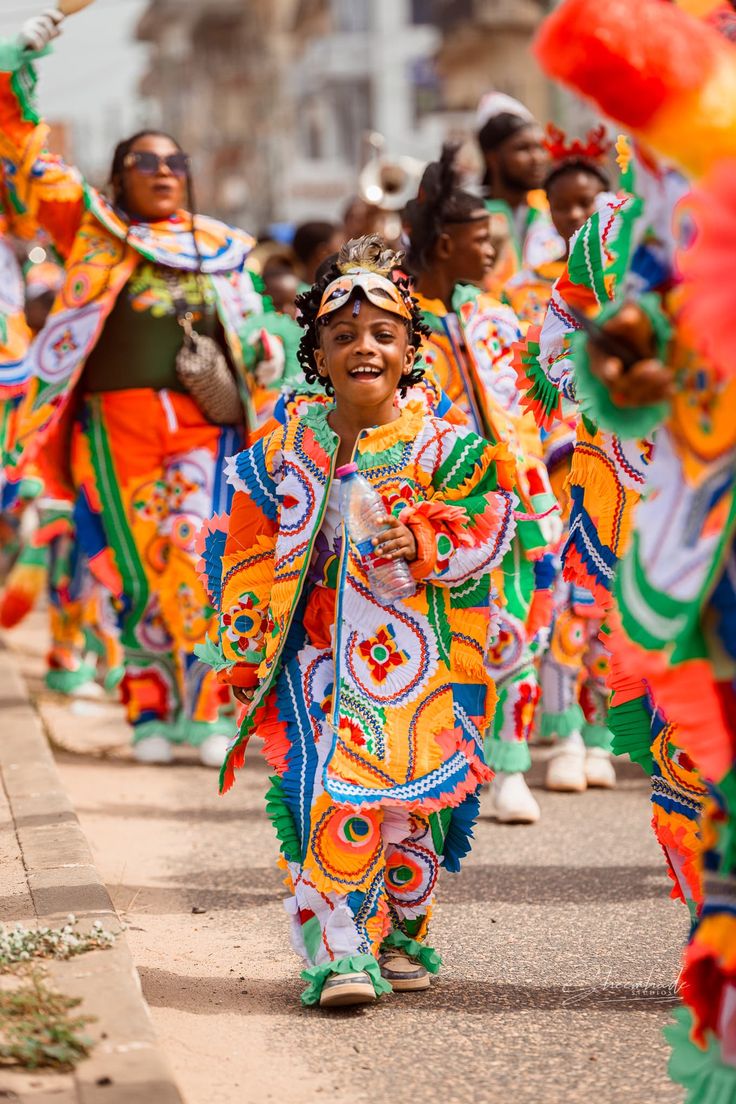 A child in colourful traditional festival costume at a Nigerian carnival